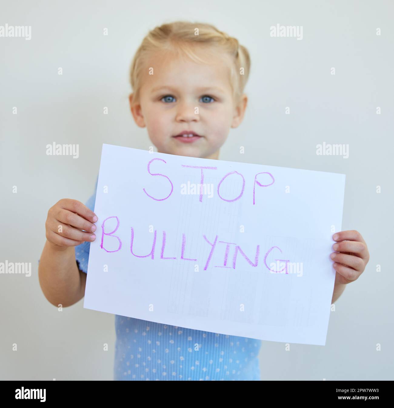 Little girl protesting against bullying with a sign. Adorable caucasian