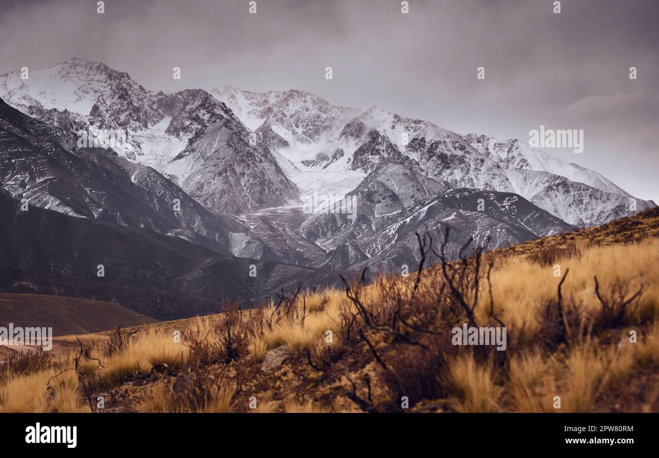 Snowy, craggy Andes mountains in Valle de Uco, Mendoza, Argentina, in a dark cloudy day. Stock Photo