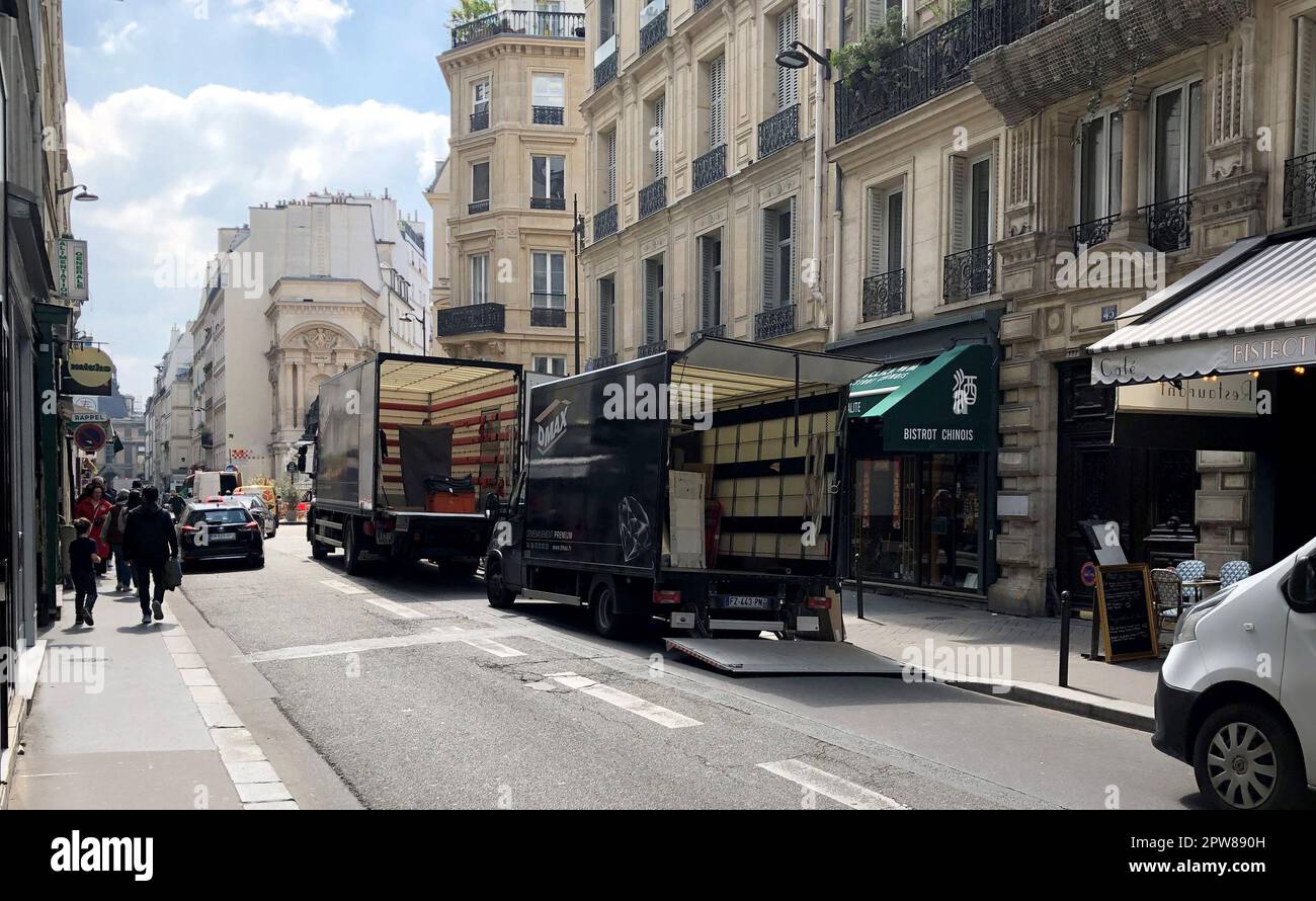 Paris, France. 18th Apr, 2023. Two moving vans are parked in the center of  the city. (to dpa: "Parisians are drawn to the provinces - home office  allows move to the countryside")