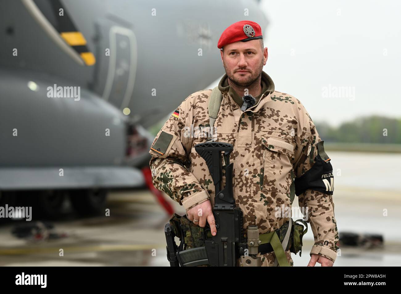 28 April 2023, Lower Saxony, Wunstorf: Lieutenant Konstantin Brabsche (40), platoon leader (II Platoon) in the 9th Company of the Feldjäger Regiment 2 in Fritzlar, Hesse, stands at the air base with his G36 rifle around his neck and his P8 pistol in a holster. The rescue mission in embattled Sudan has demanded a lot from the Bundeswehr soldiers involved. As Lieutenant Brabsche, who was responsible for the security lock at the airfield near the capital Khartoum with the military police, reported after his return, the troops had to work in a highly complex and fast manner under improvised condit Stock Photo