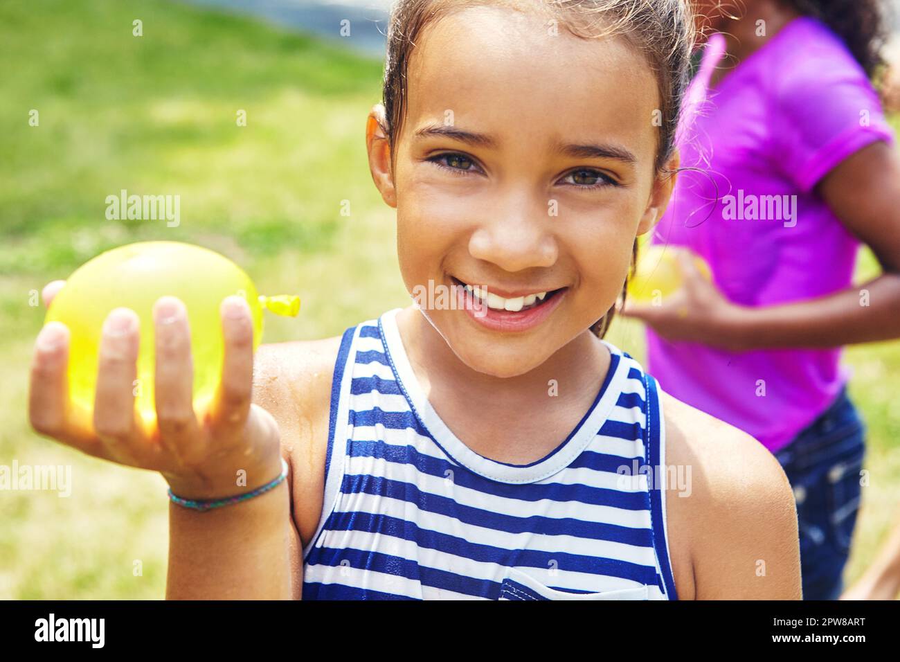 Im going to make them all wet. Portrait of an adorable little girl playing with water balloons