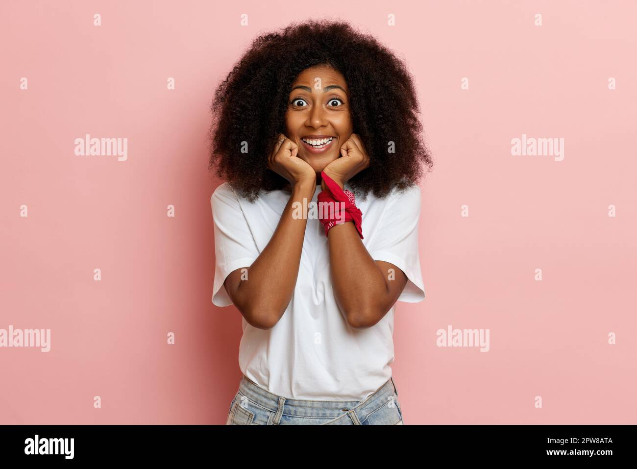 Happy African American woman, keeps hands under chin and smile. High quality photo Stock Photo