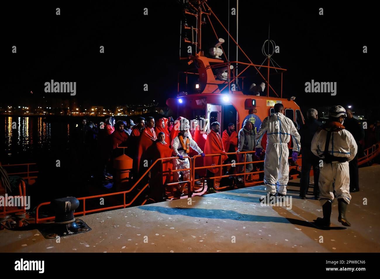 Migrants, who were rescued from a dinghy at the Mediterranean Sea, are ...