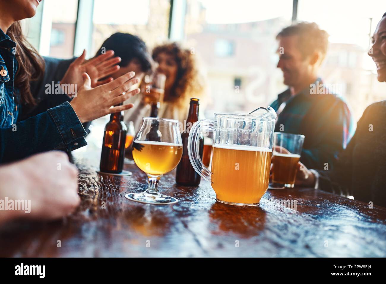 Ready to refresh. a jug of beer on a counter at a bar. Stock Photo