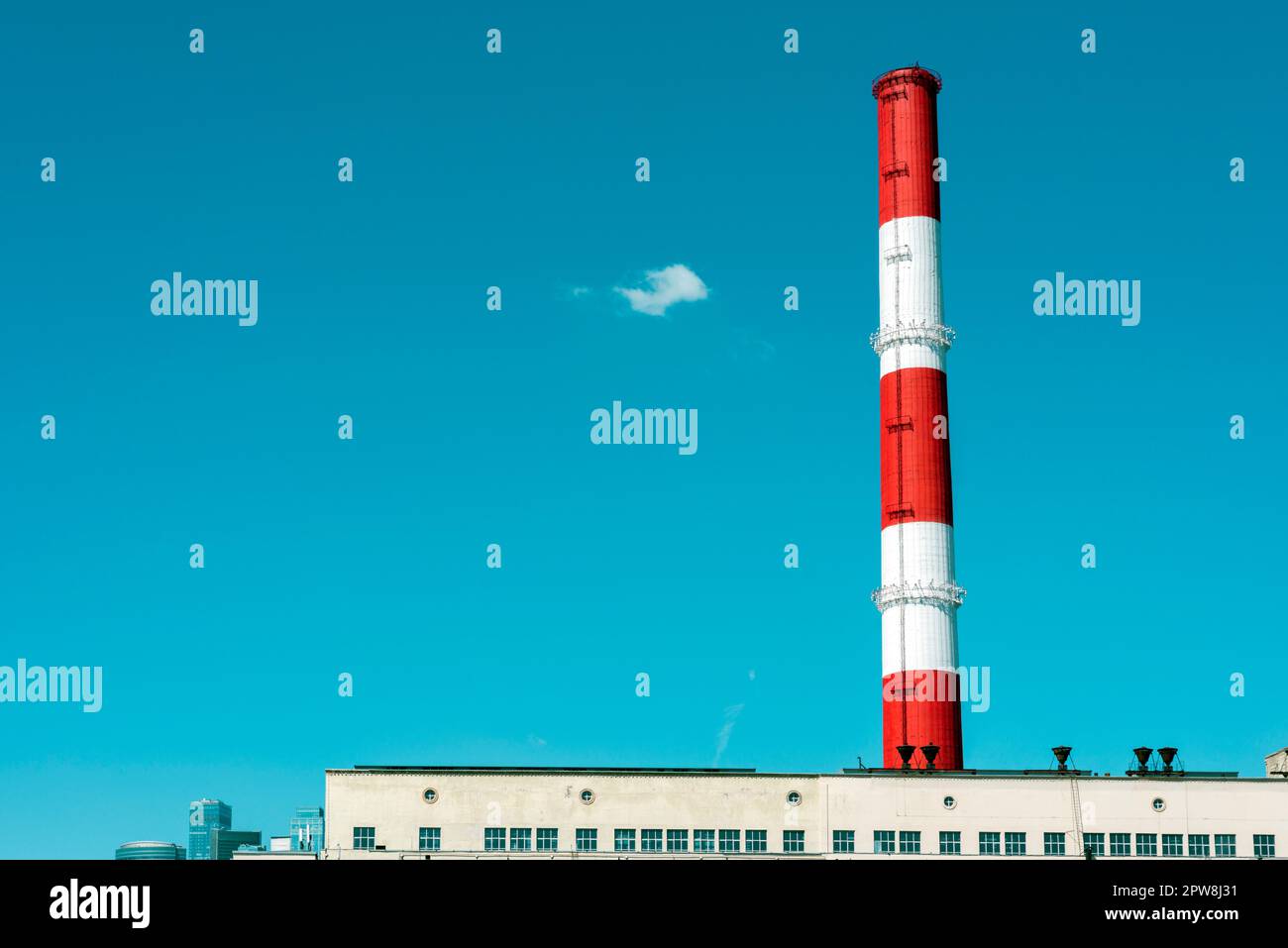 huge red-white striped chimney with blue sky behind Stock Photo - Alamy