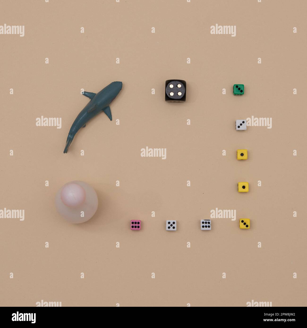 Cubes of various sizes and colors with a gray shark on a beige ...