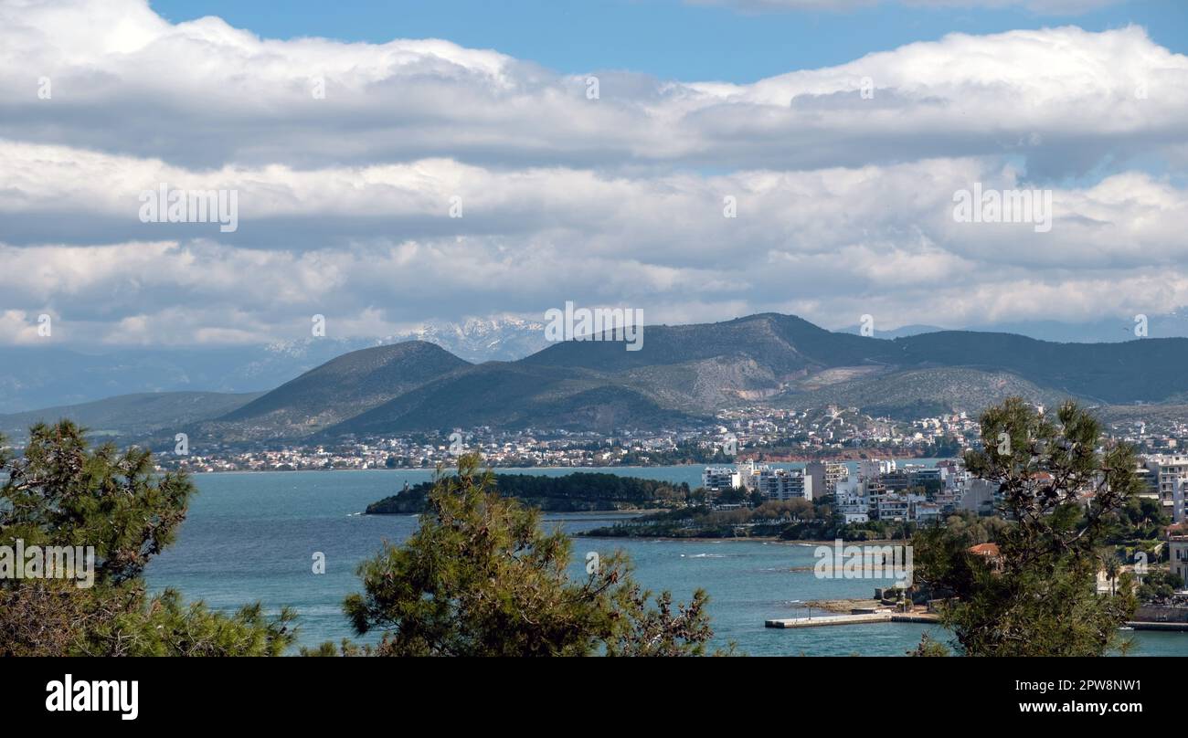 Greece, destination city of Chalkida at Evia island. View of seafront Halkida from Karababa castle, building, Euripus Strait, cloudy sky background. Stock Photo
