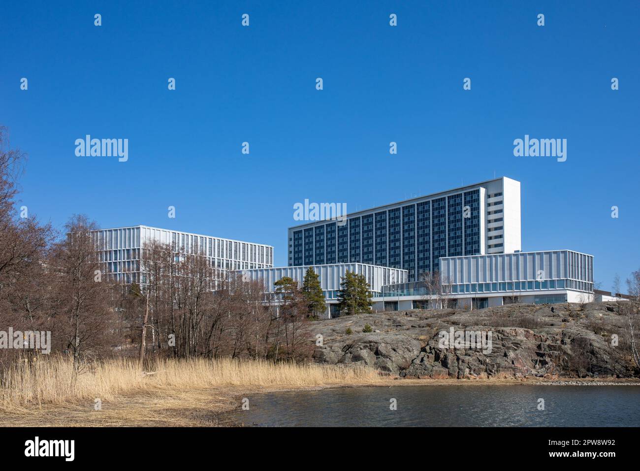 Siltasairaala and Tornisairaala hospitals by Humallahti Bay against clear blue sky on a sunny spring day  in Meilahti district of Helsinki, Finland Stock Photo