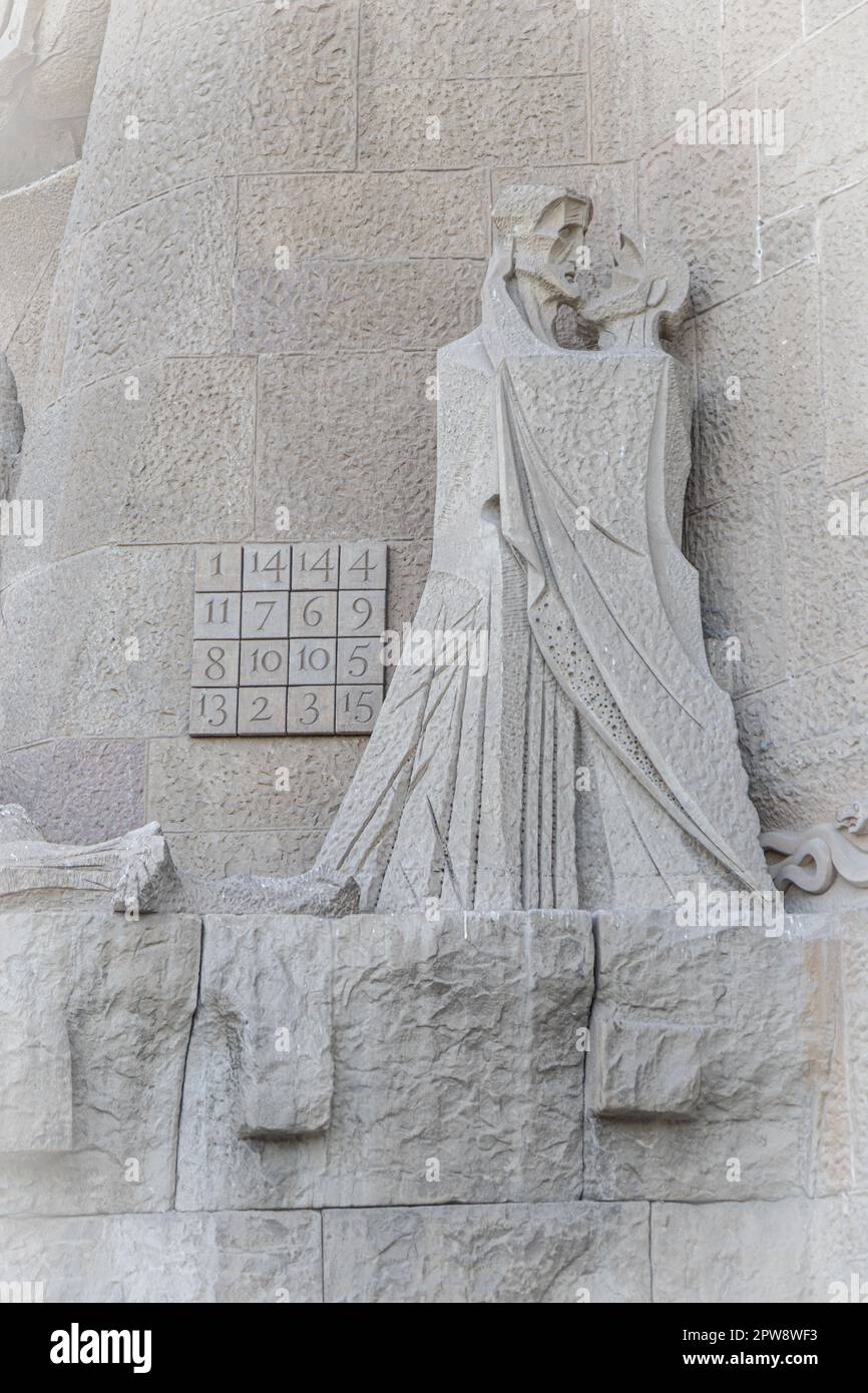 BARCELONA, SPAIN-AUGUST 22, 2022: Magic square and Kiss of Judas sculpture on Passion Facade of Sagrada Familia Stock Photo