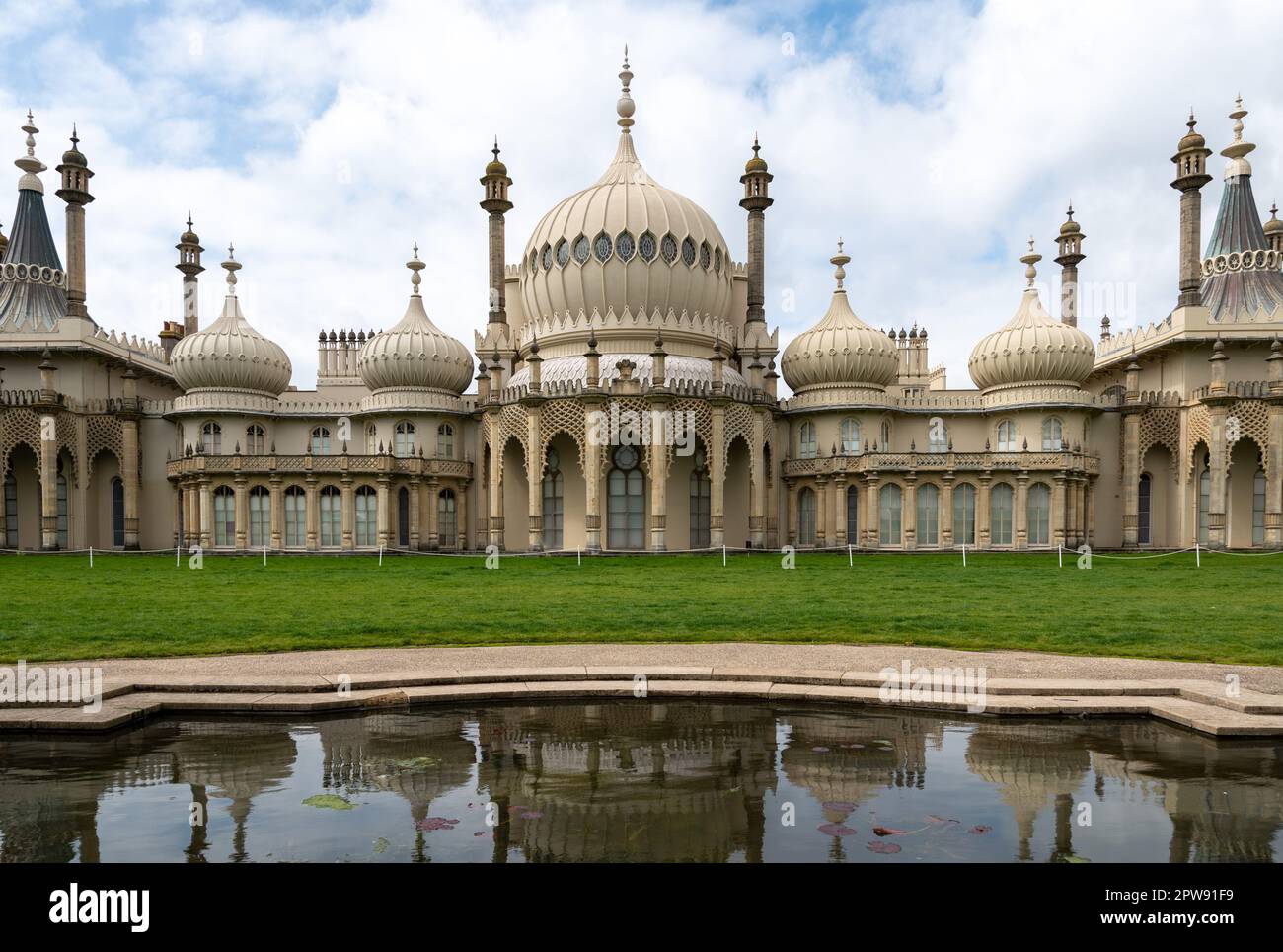 Exterior of Brighton's Royal Pavilion with reflections from a pond in front of it. April 2023. Stock Photo