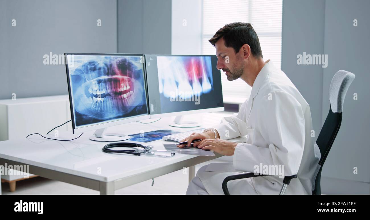 Radiologist Dentist Using X Ray Software On Desktop Computer Stock