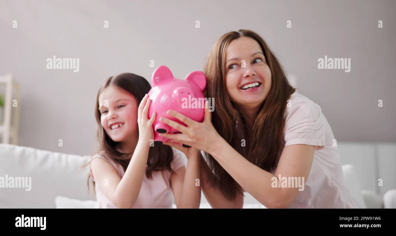Mom and daughter saving money hi-res stock photography and images - Alamy