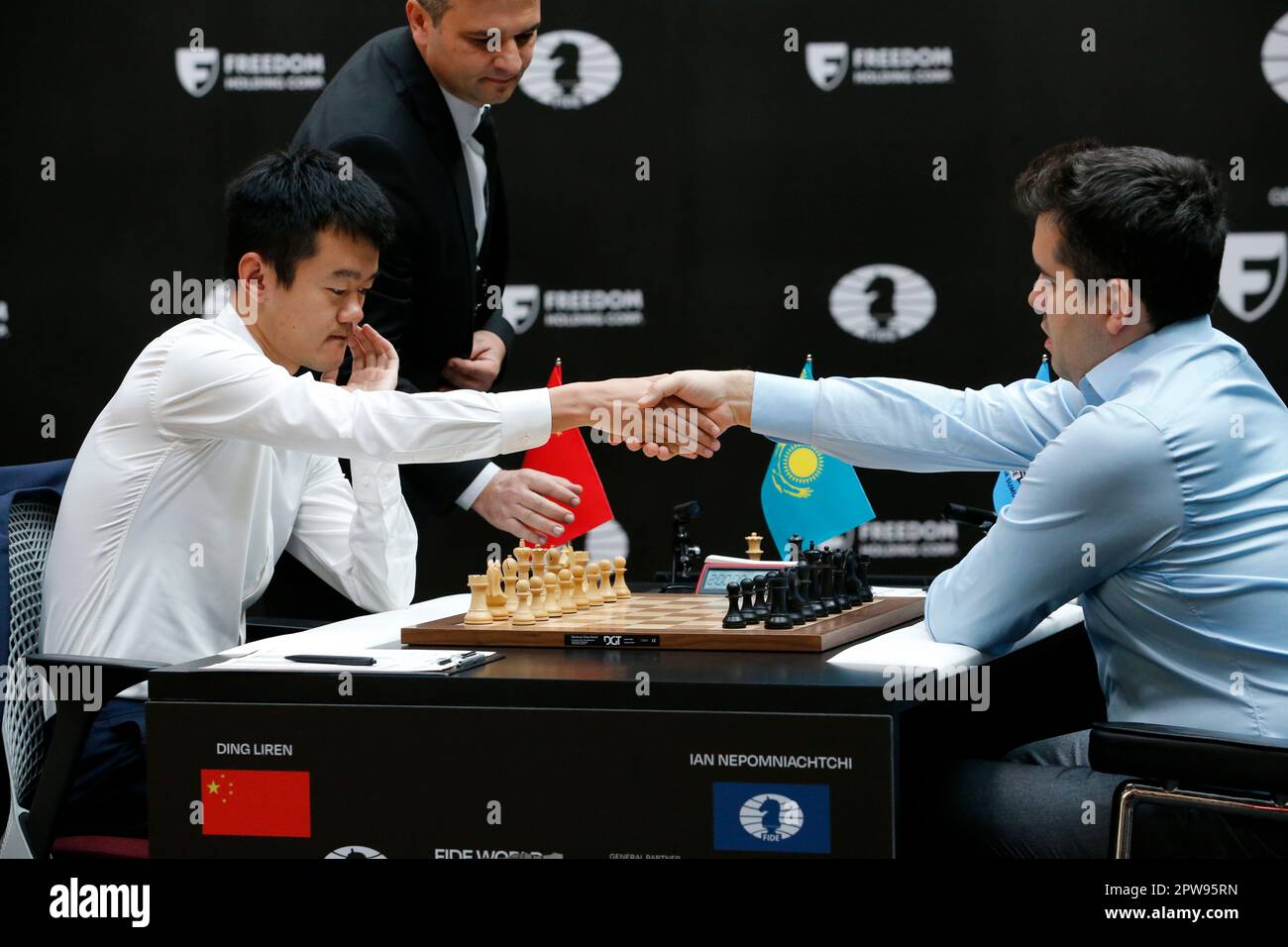 China's Ding Liren, left, and Russia's Ian Nepomniachtchi shake hands prior  to their FIDE World Chess Championship in Astana, Kazakhstan, Saturday,  April 29, 2023. Ian Nepomniachtchi and Ding Liren are facing off