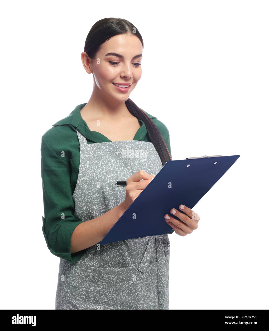 Young woman in grey apron with clipboard on white background Stock ...