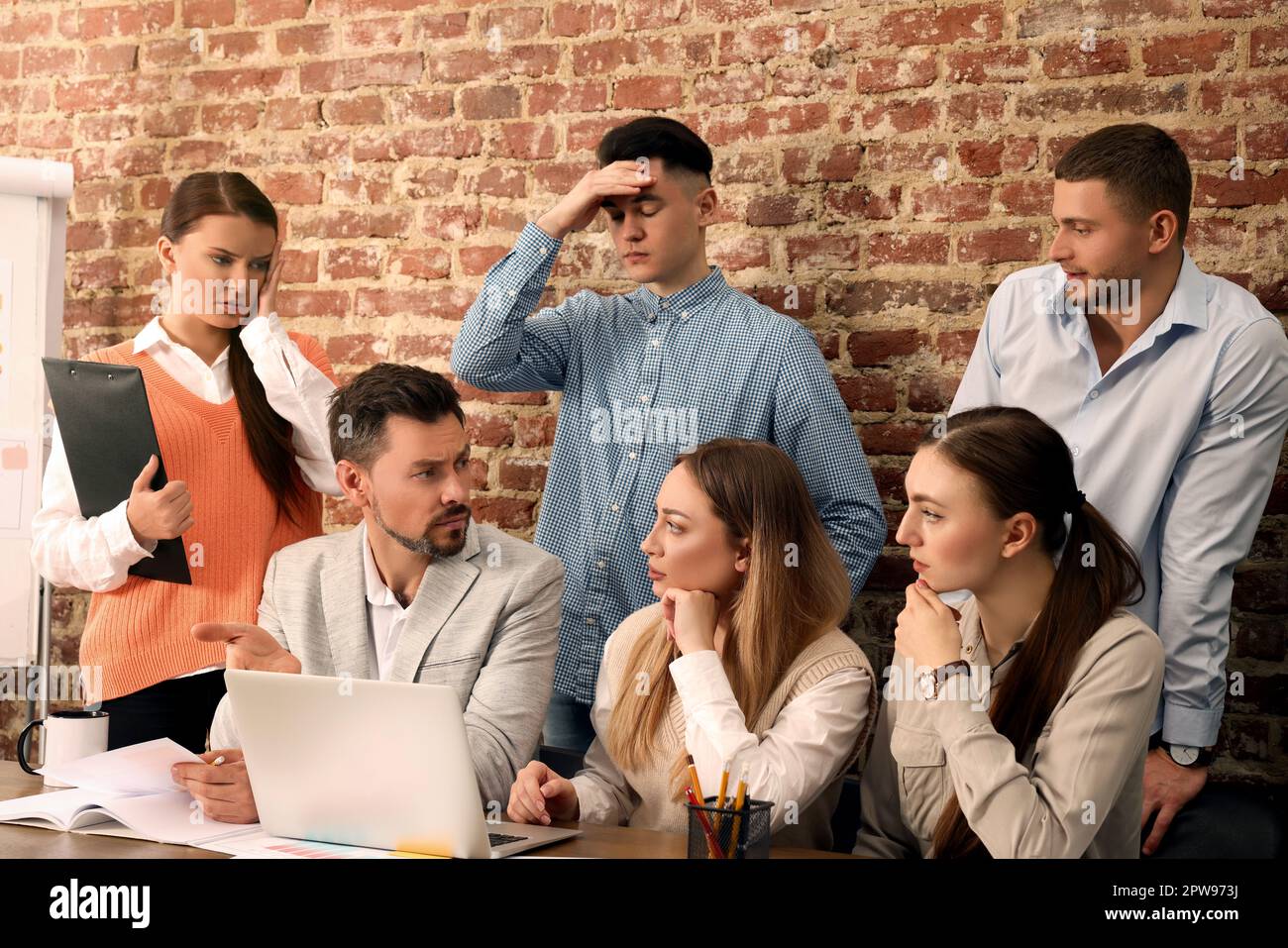 Team of employees working together on difficult task in office Stock ...