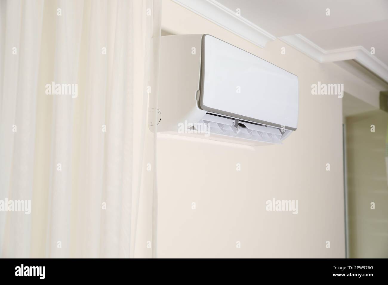 Modern air conditioner on white wall indoors Stock Photo - Alamy
