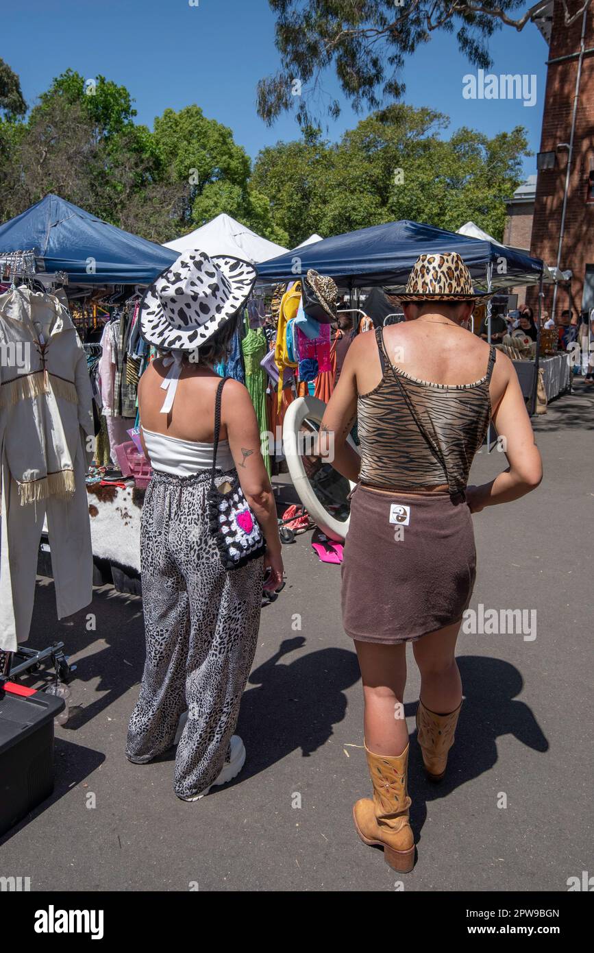 Women in toy cowboy hats browsing and shopping at the long running weekend markets at Glebe in Sydney Australia. Glebe Markets Stock Photo
