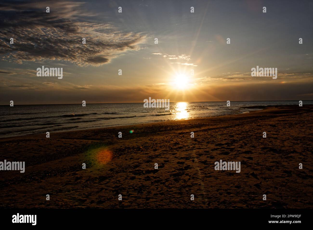 The setting sun in Bella Vista beach in Uruguay Stock Photo