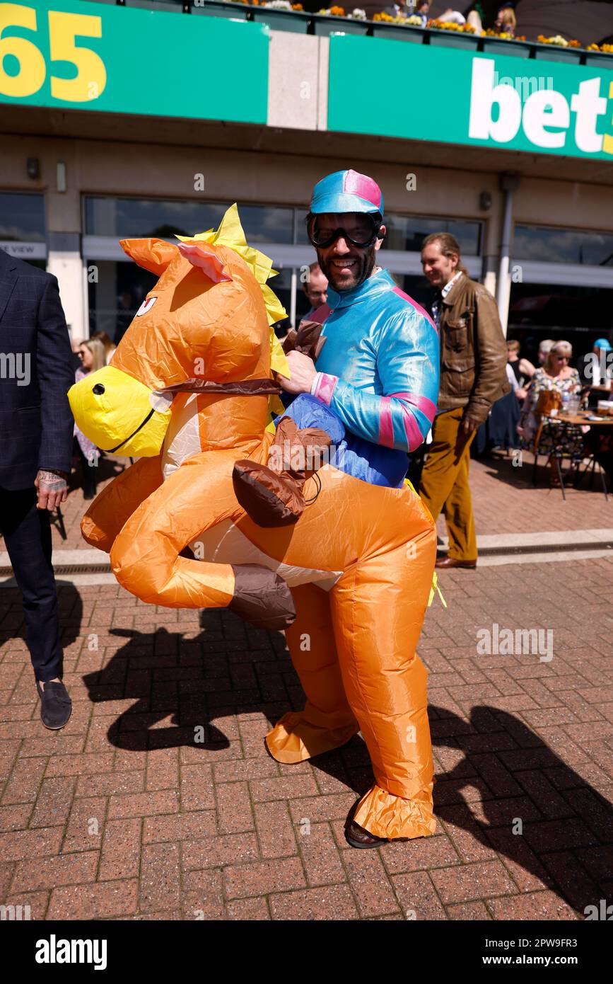 A racegoer in a horse and jockey fancy dress at Sandown Park Racecourse Surrey. Picture date Saturday April 29 2023 Stock Photo Alamy
