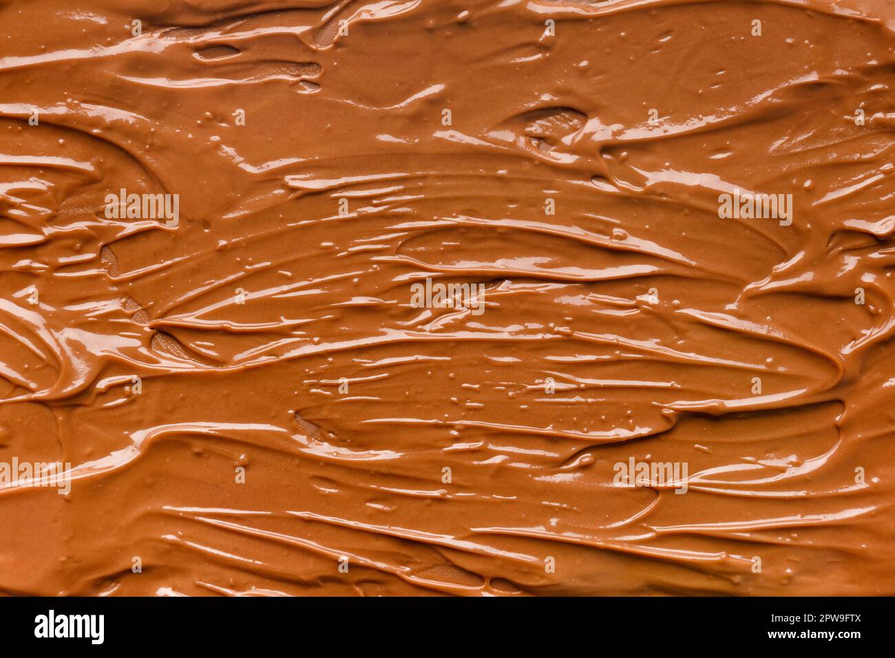 Chocolate background. Melted chocolate. Liquid milk chocolate. Handmade