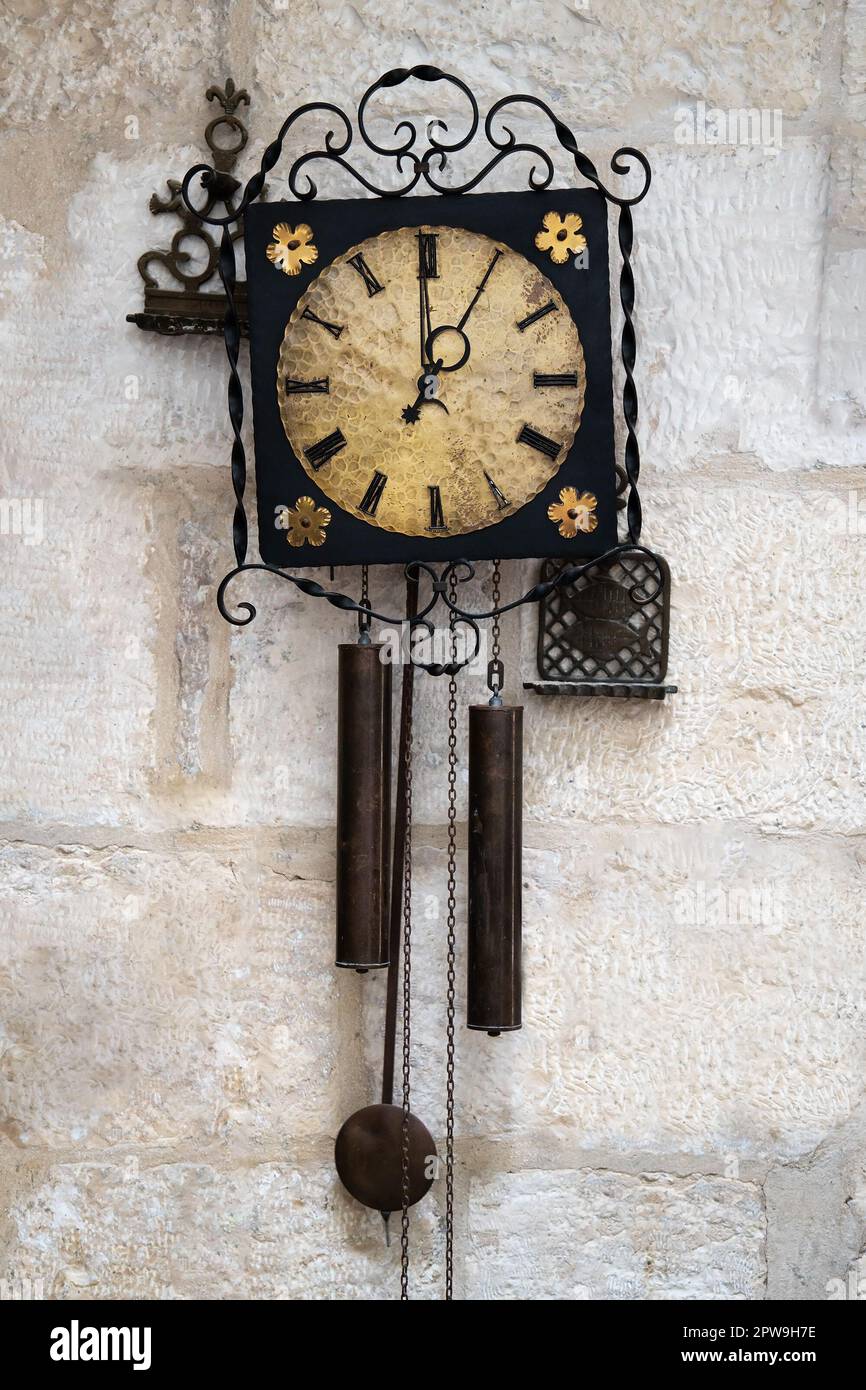 Old pendulum clock on the white stone wall Stock Photo Alamy