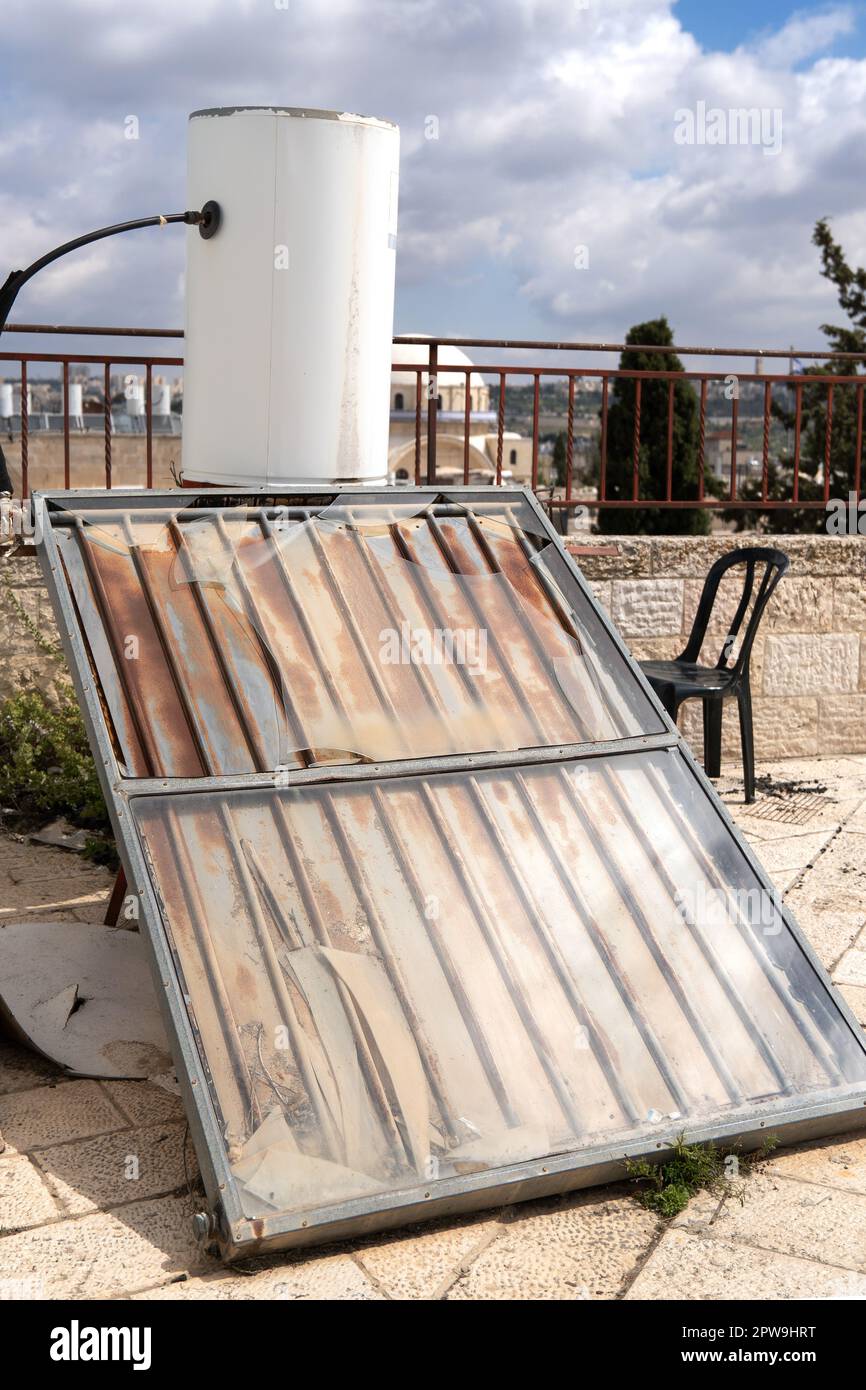 Old solar water heating system on the residential house roof Stock