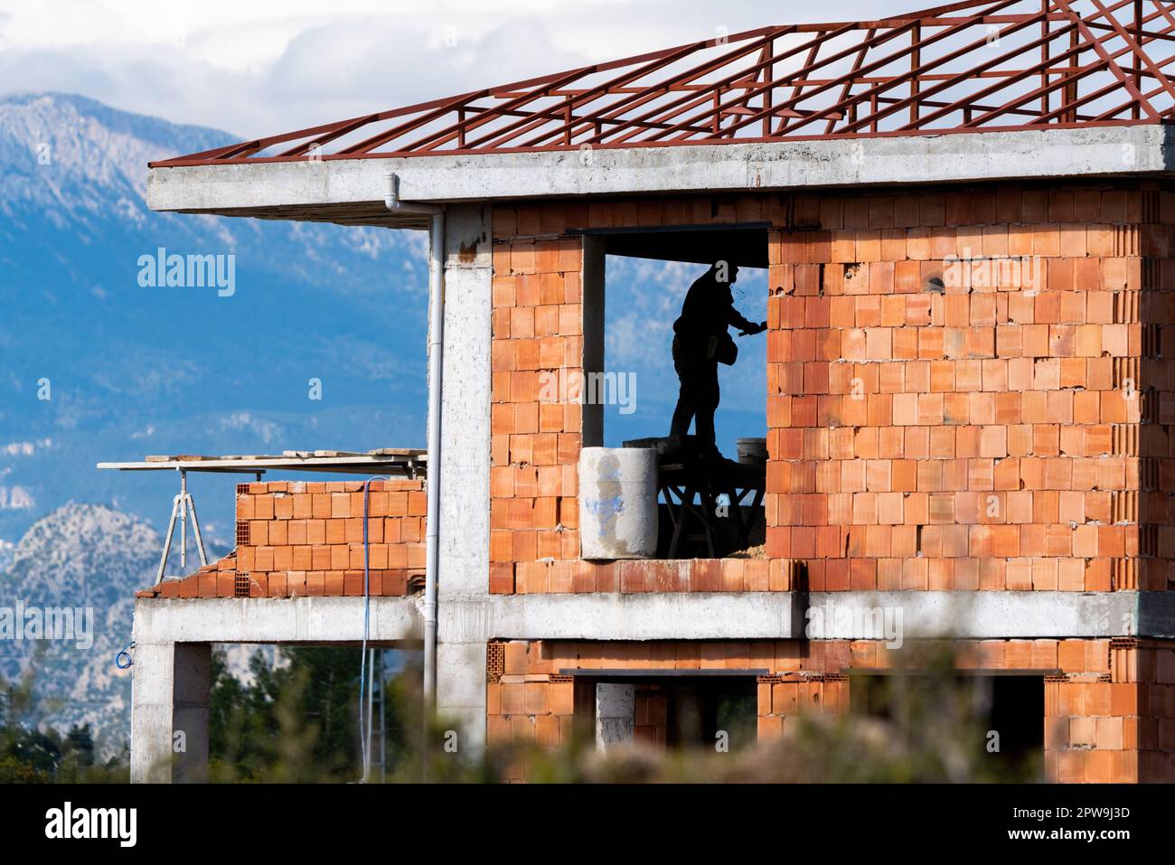A plaster labourer working in villa construction, Villa construction. Stock Photo