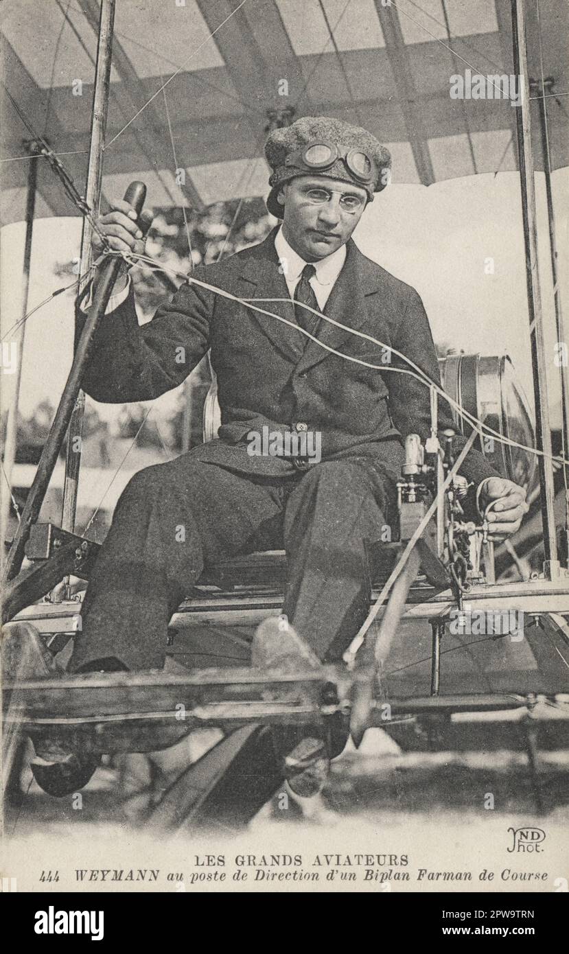 France. c.1910. An antique postcard entitled, “Les Grands Aviateurs – Weymann au poste de Direction d’un Biplan Farman de Course' (The Great Aviators – Weymann at the controls of a Farman biplane). It depicts the early aeroplane racing pilot and businessman, Charles Terres Weymann . During the First World War he flew for Nieuport as a test pilot and was awarded the rank of Chevalier of the Legion of Honour. Stock Photo