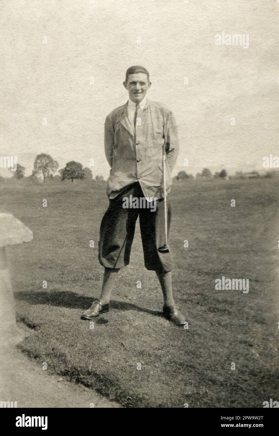 England. 1930s. A gentleman golfer posing for a photograph wearing plus fours and carrying a ‘brassie’ type golf club. Stock Photo