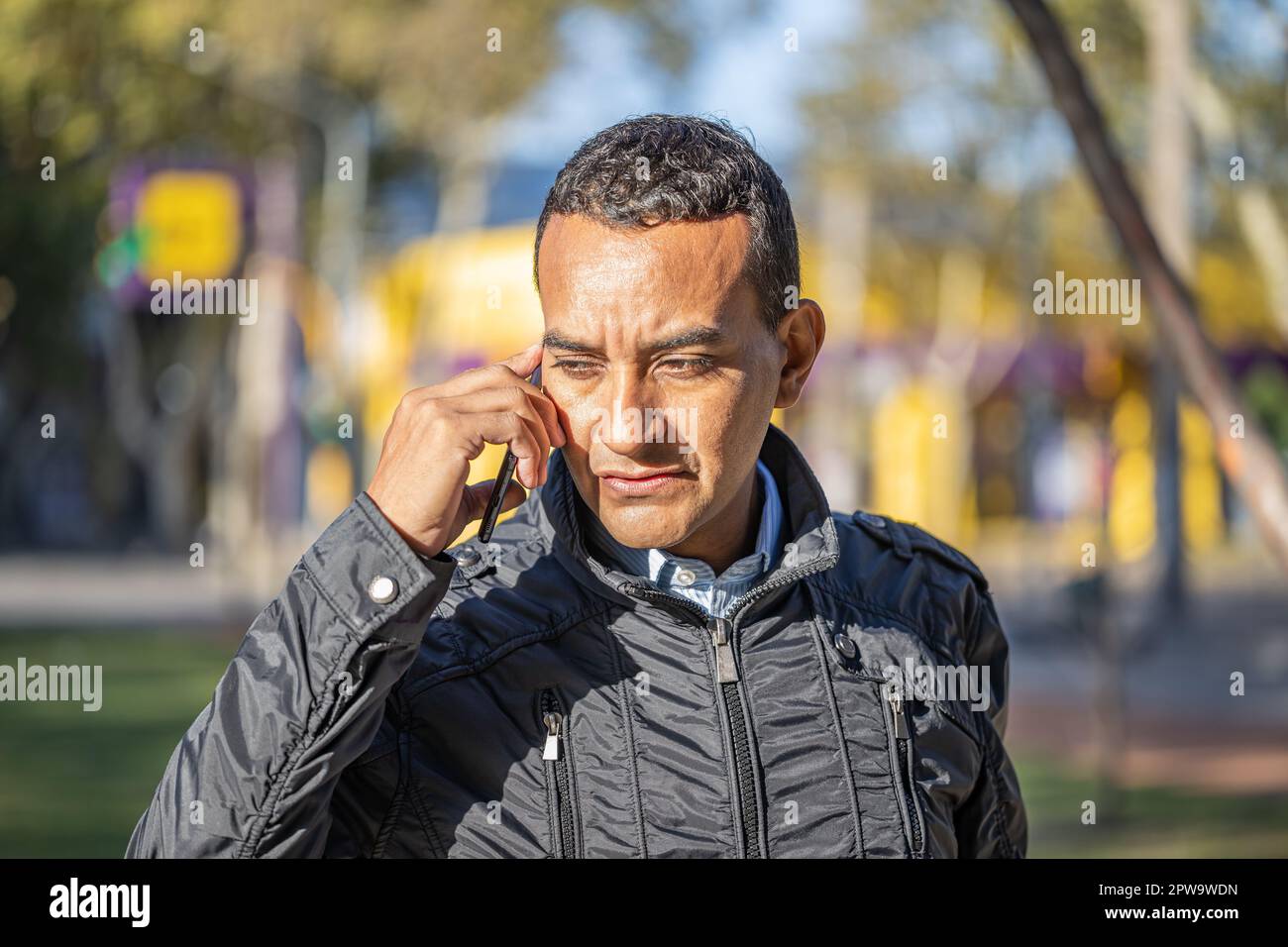 Latin young man talking on mobile phone. Stock Photo