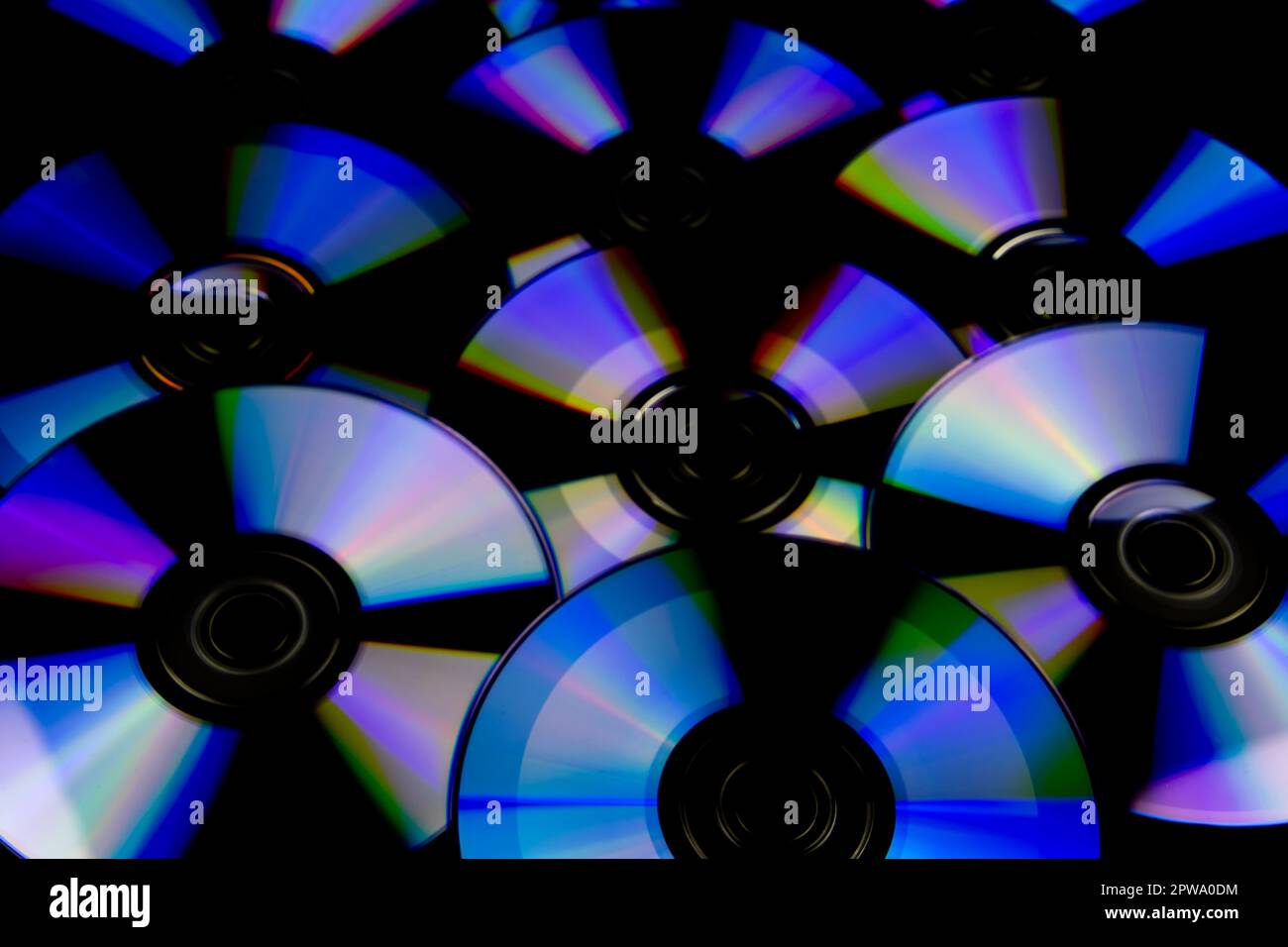 CD and DVD isolated on black background with colorful light reflections