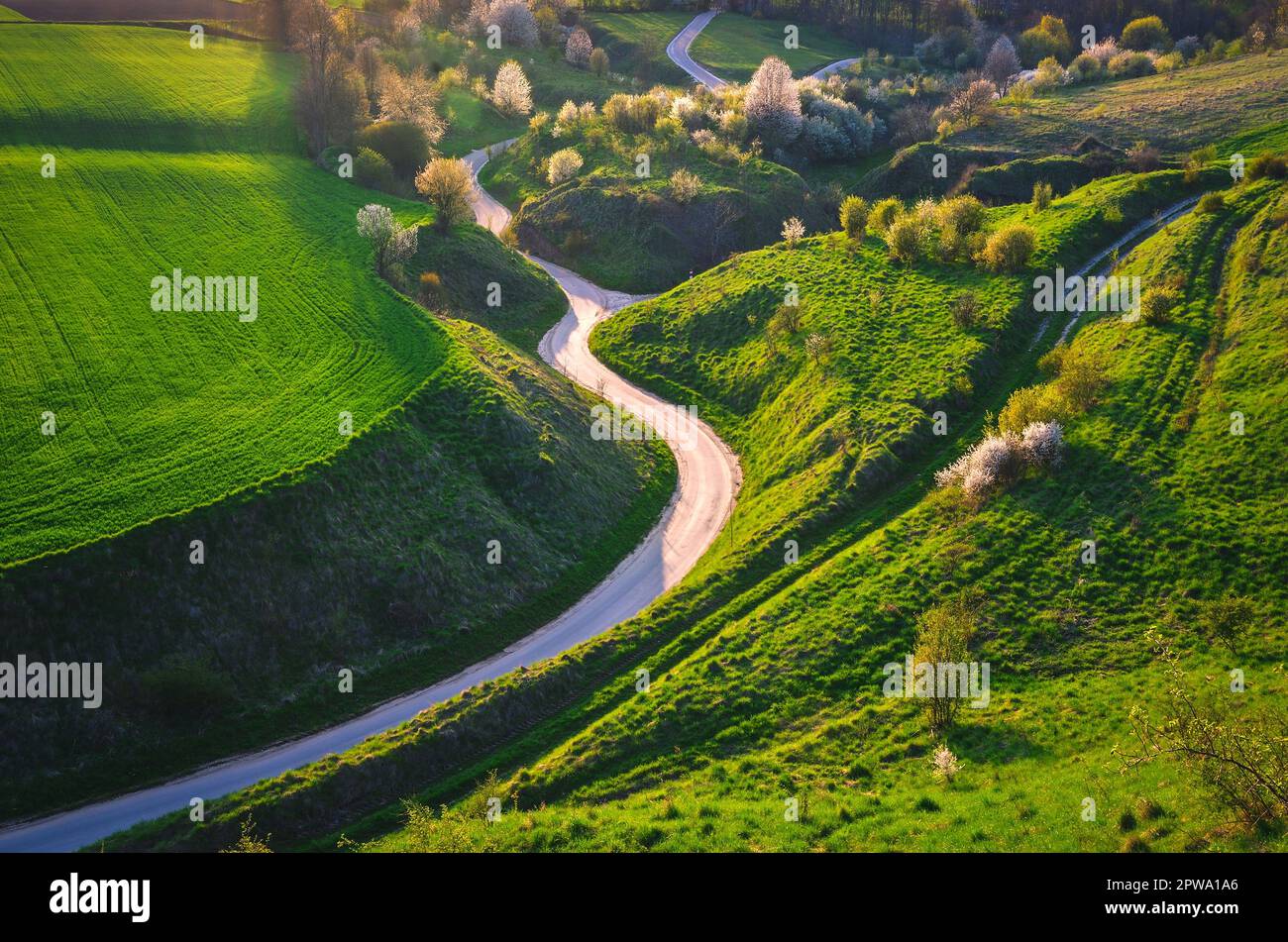 Top view scenic winding country road through green farmland. Clip. Aerial  rural road countryside Stock Photo - Alamy
