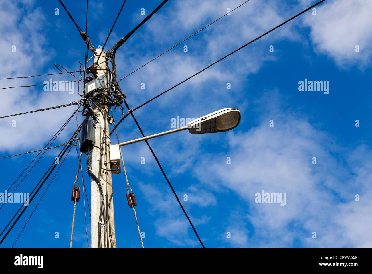 A telegraph pole carrying overhead electricity and telephone lines in