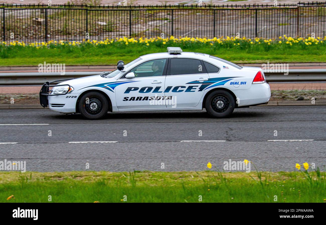 An American Sarasota Cop car travelling along the Kingsway West Dual Carriageway in Dundee, Scotland Stock Photo