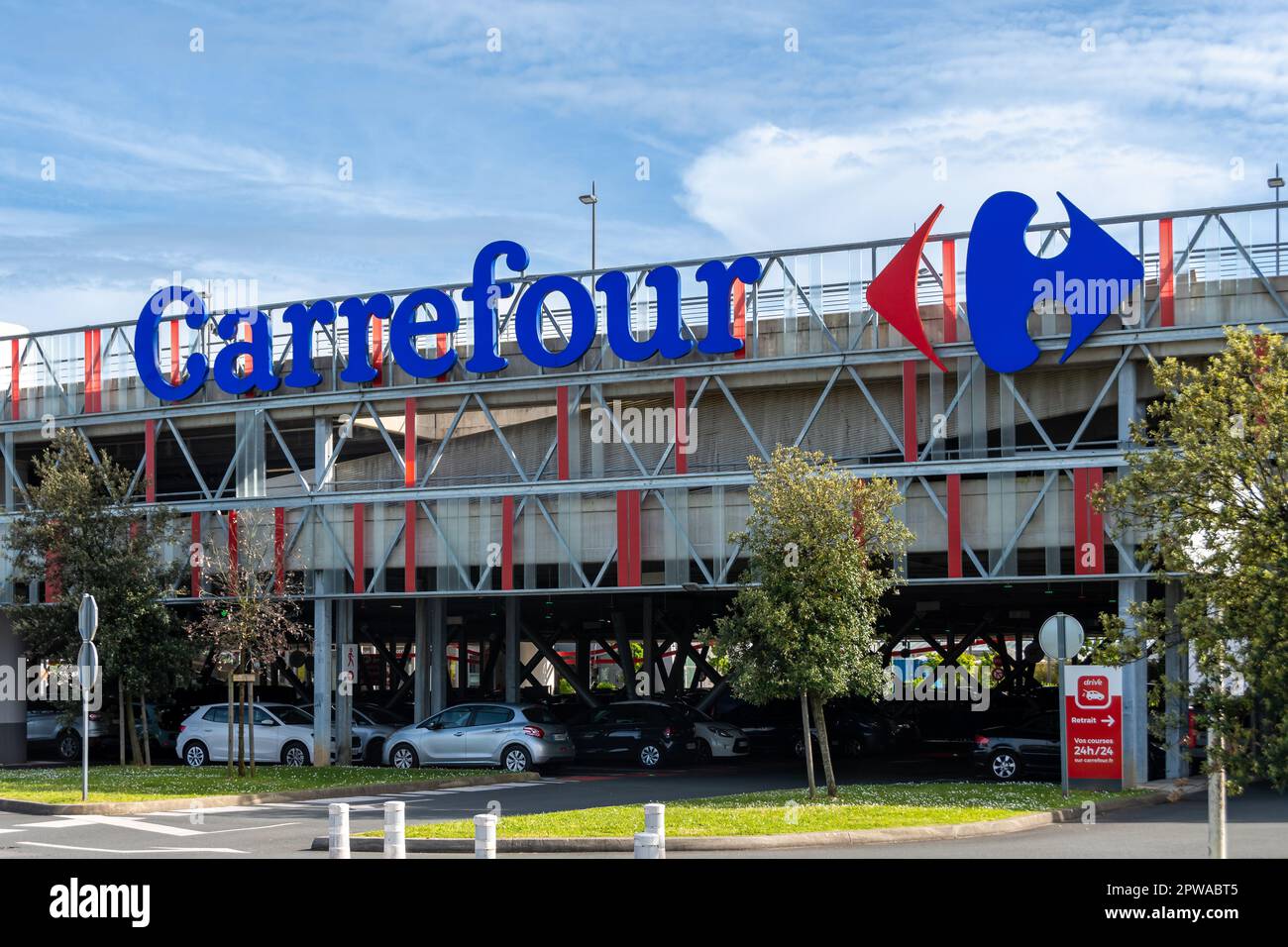 Commercial sign and logo of the Carrefour hypermarket located in the BAB2 shopping center in Anglet, France Stock Photo