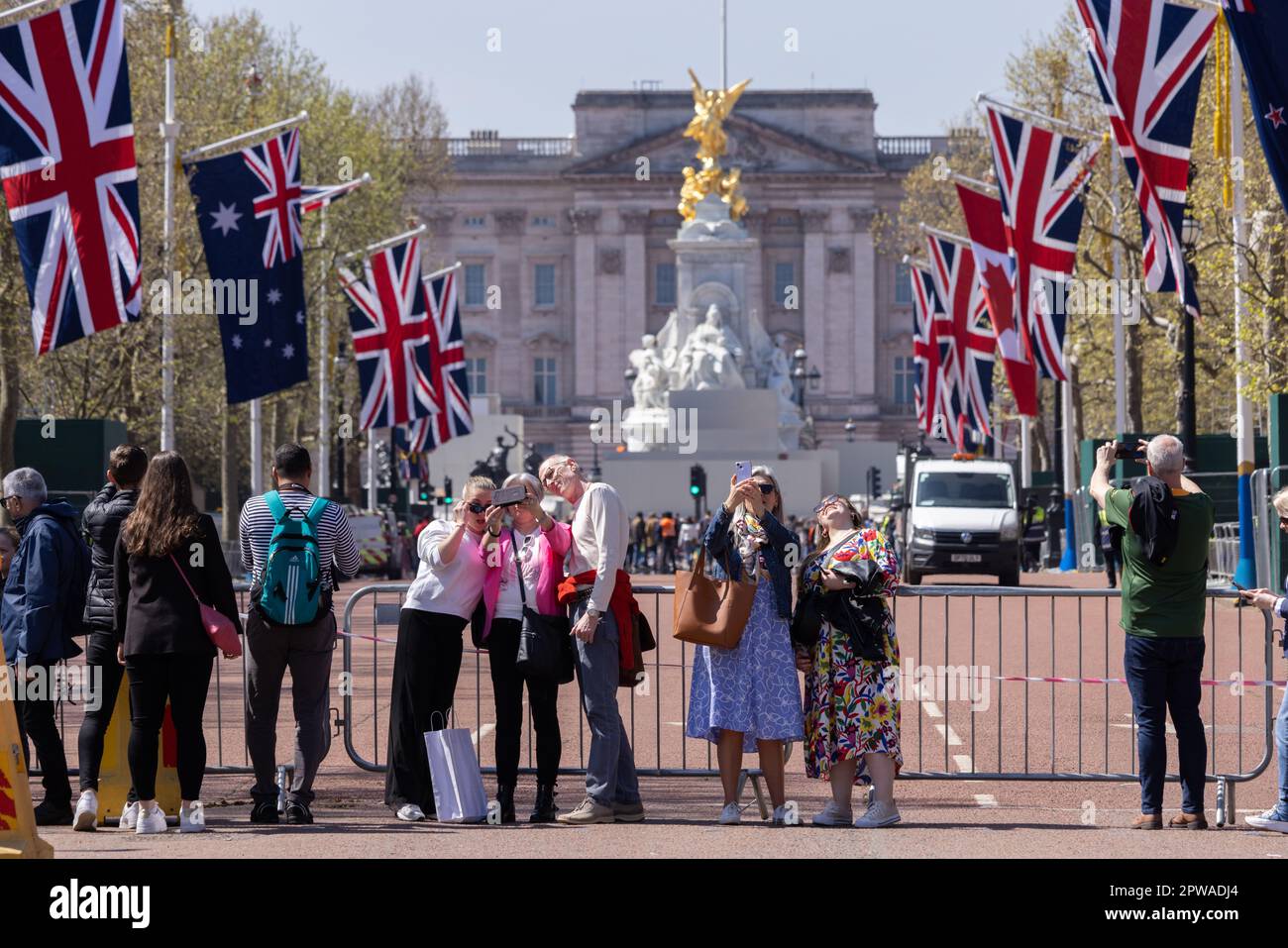 Tourists gather along The Mall to enjoy the build up and preparations in london ahead of the Coronation of King Charles III, London, England, UK Stock Photo