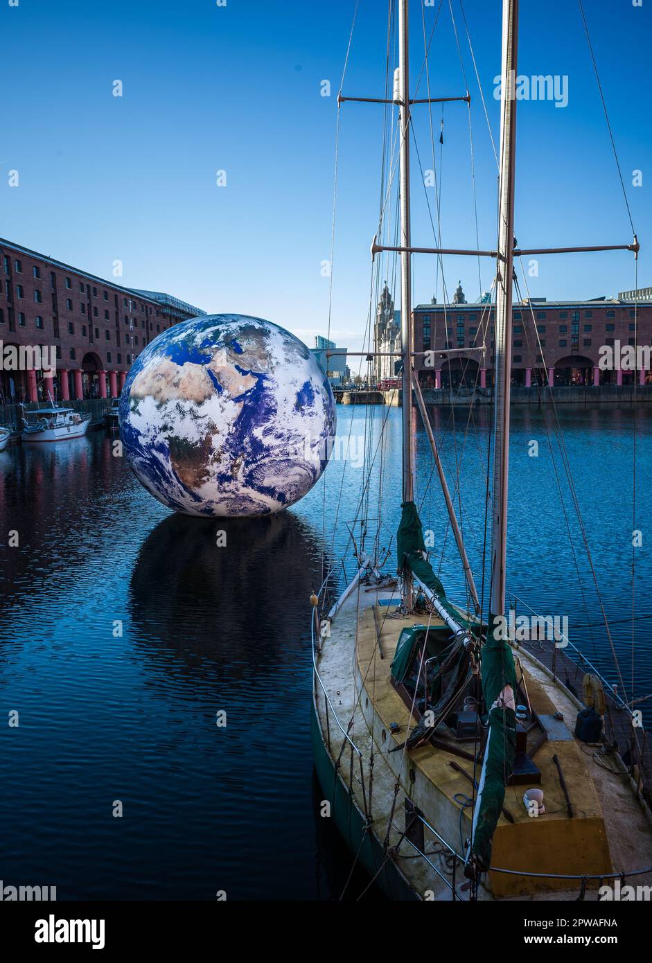 Floating Earth by Luke Jerram at  the Royal Albert Dock's inner quay, Liverpool as the 'jewel' in the site's Eurovision calendar Stock Photo