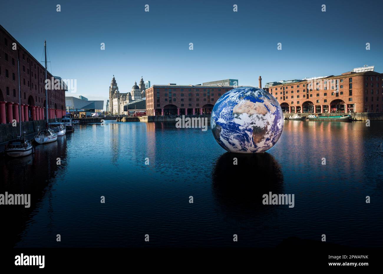 Floating Earth by Luke Jerram at  the Royal Albert Dock's inner quay, Liverpool as the 'jewel' in the site's Eurovision calendar Stock Photo