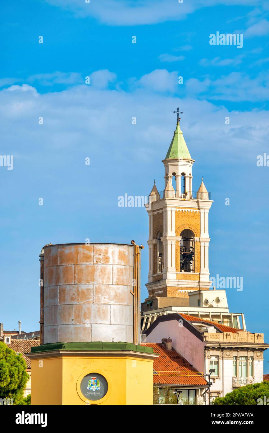 Former railway silos with the bell Tower of the church of the Sacro Cuore di Gesù in the background, Pescara, Italy Stock Photo