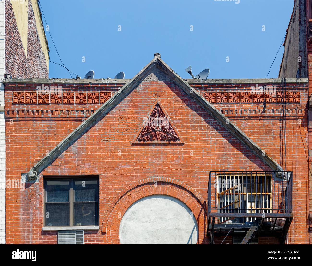 Once an Orthodox Jewish synagogue, red brick 209 Madison Street was converted to apartments. The prominent rose window was closed with concrete. Stock Photo
