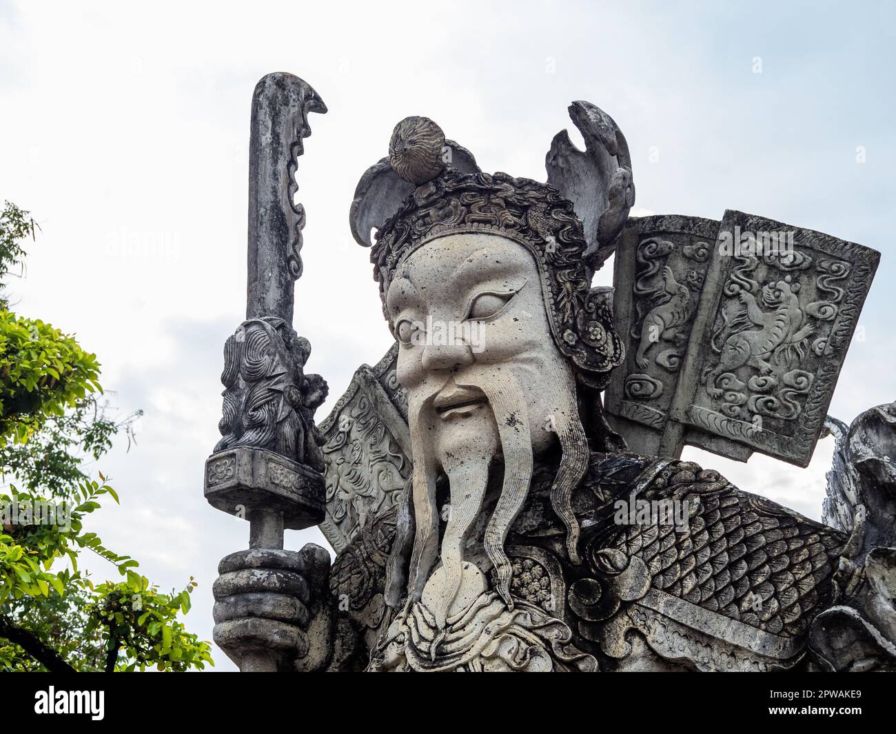 A historic Chinese warrior statue made of stone, located in the serene