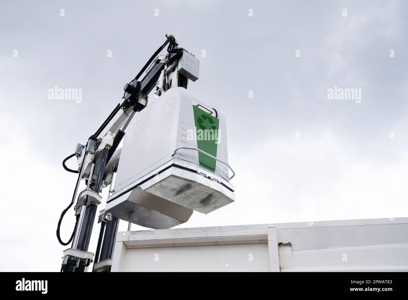 Garbage truck lifts street bin for recyclable waste. High quality photo Stock Photo