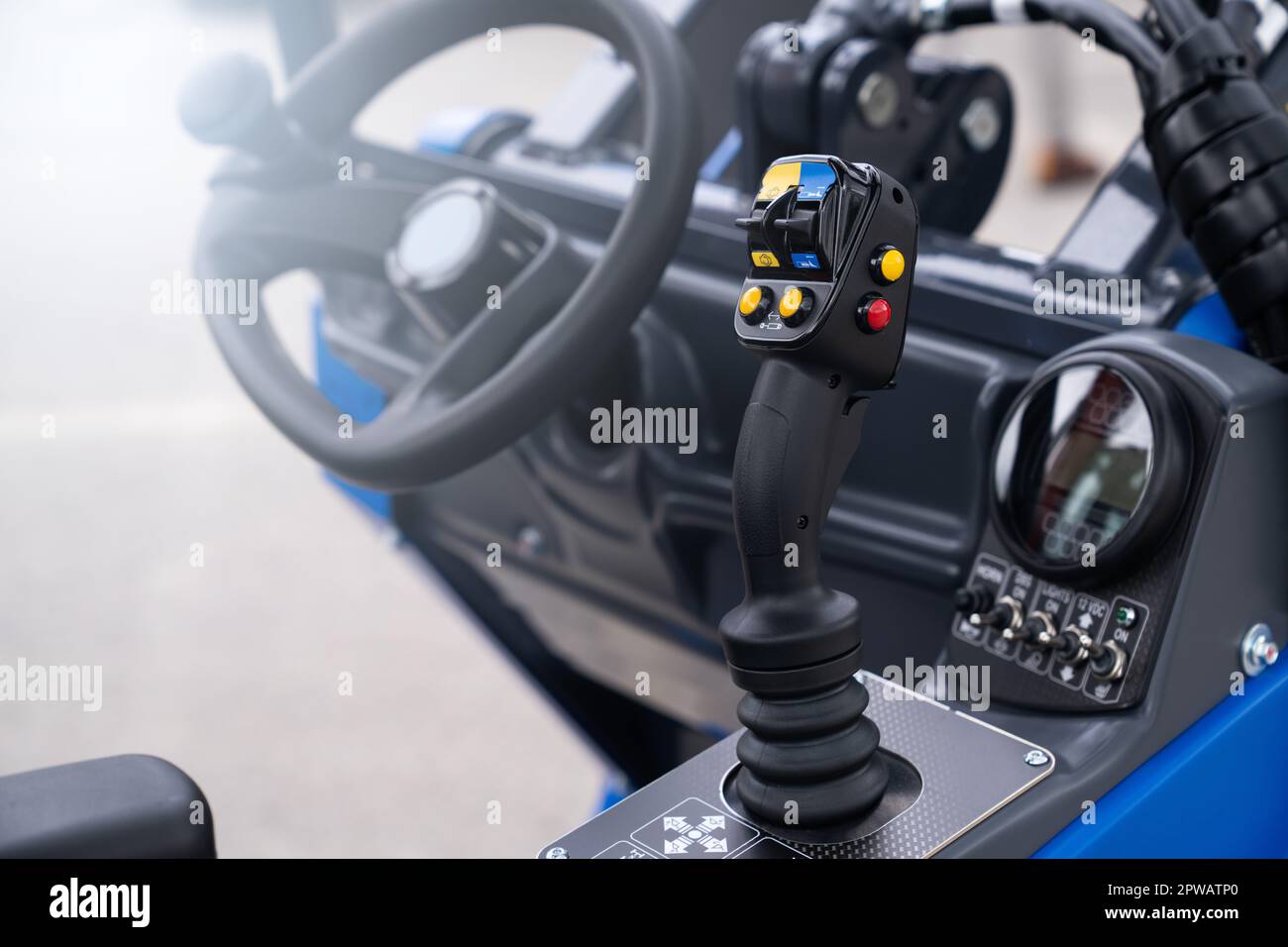 Steering wheel and joystick to drive a tractor. High quality photo Stock Photo
