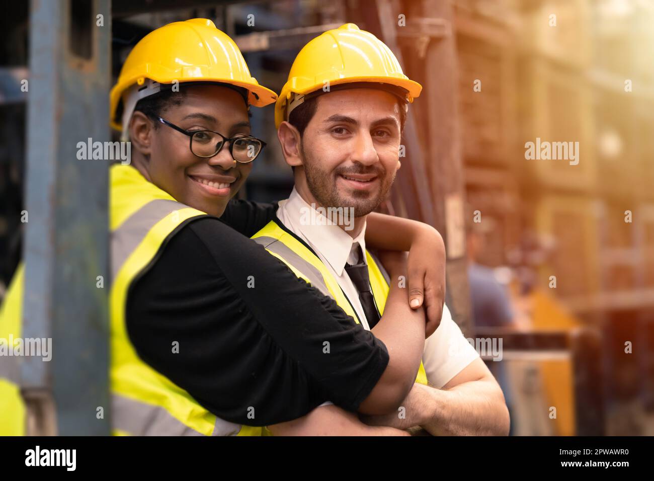 Happy industry worker friends working together mix race gender. black woman with hispanic latin man. Stock Photo