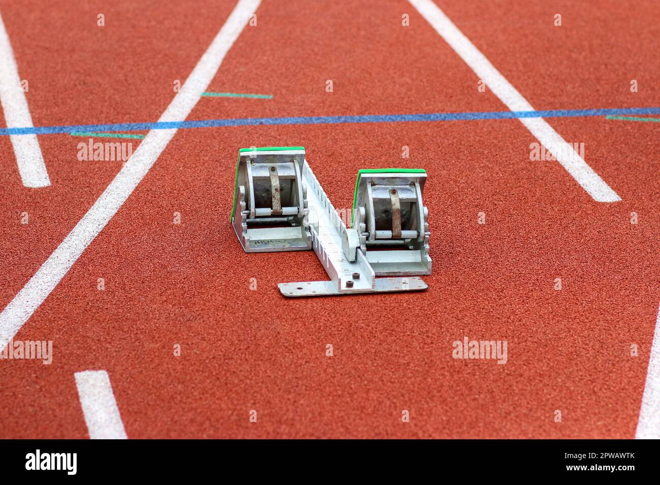 A track sprinters starting blocks set up on a red track Stock Photo Alamy