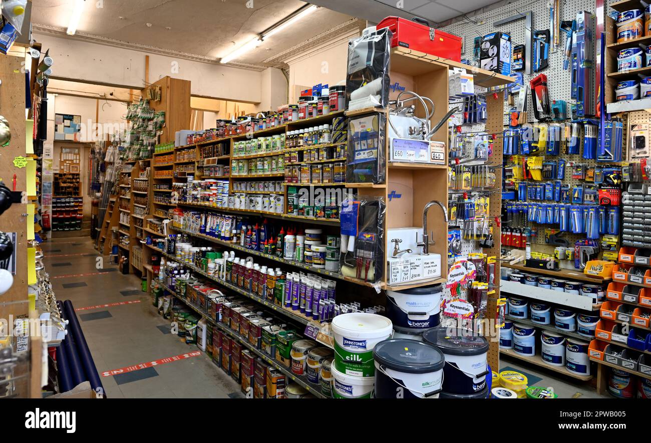 Inside high street independent hardware store with shelves of paints, displays of tools, UK Stock Photo