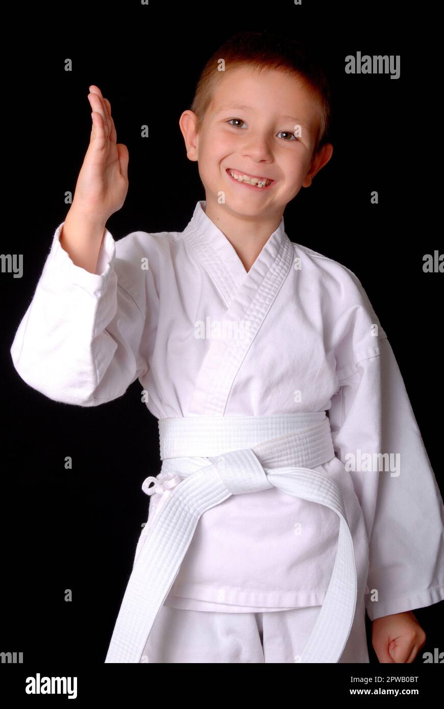 Young boy in karate outfit making fighting movement Stock Photo Alamy