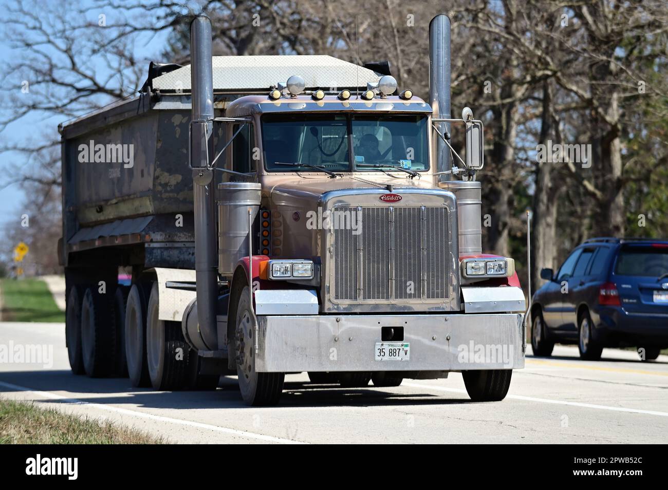 Streamwood, Illinois, USA. A truck passing through a wooded area