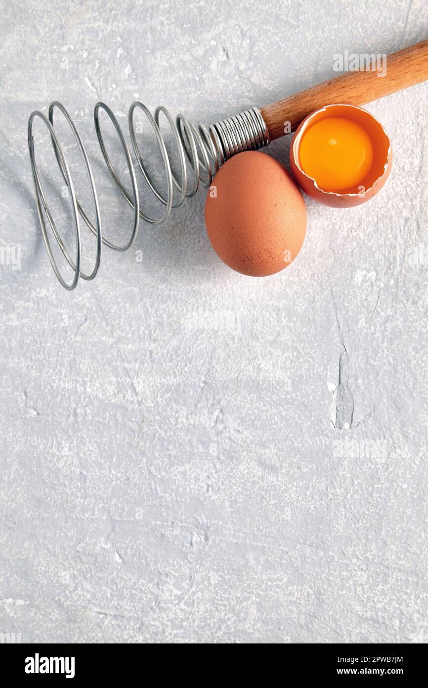 https://c8.alamy.com/comp/2PWB7JM/two-beige-chicken-eggs-and-a-rare-beater-for-beating-cooking-ingredients-isolated-on-white-background-top-view-with-copy-space-2PWB7JM.jpg