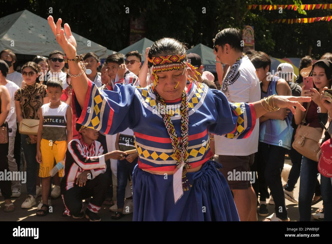 Malaybalay City, Philippines - ethnic tribal groups in Bukidnon join in a community street dance during the Kaamulan Festival. Colorful indigenous event. Stock Photo